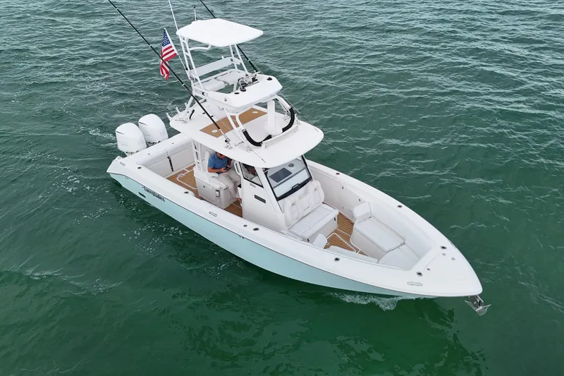 The Image of 2018 Everglades 335 Center Console boat cruising on open water, featuring dual engines. - 0