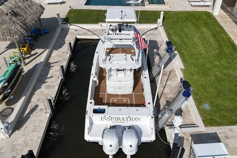 Slide: The Image of 2018 Everglades 335 Center Console boat docked, aerial view, with American flag. - 12