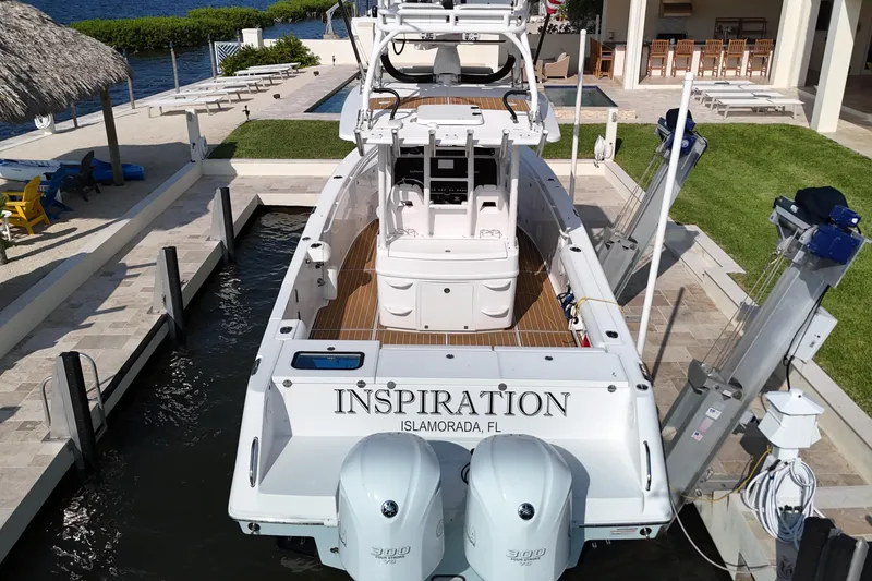 Slide: The Image of 2018 Everglades 335 Center Console boat docked, named "Inspiration," in Islamorada, Florida. - 13