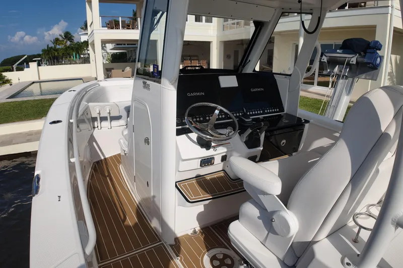 Slide: The Image of 2018 Everglades 335 Center Console boat interior with modern helm and seating. - 24