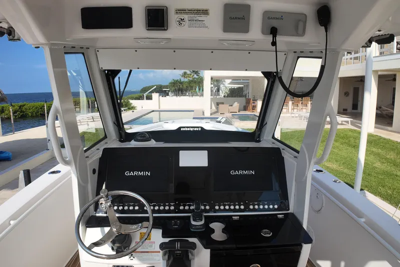 Slide: The Image of 2018 Everglades 335 Center Console boat cockpit with Garmin navigation system, ocean view. - 27