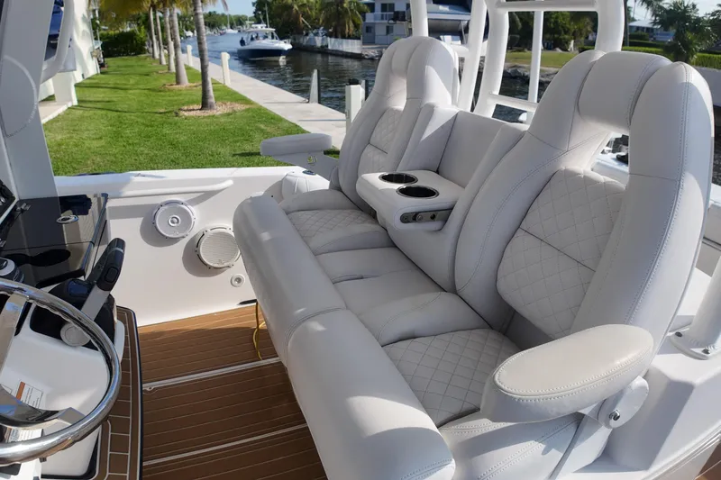 Slide: The Image of Luxurious seating on 2018 Everglades 335 Center Console boat, featuring plush white upholstery. - 28
