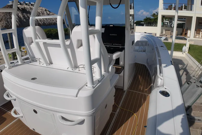 Slide: The Image of 2018 Everglades 335 Center Console boat with sleek design and modern navigation system. - 29