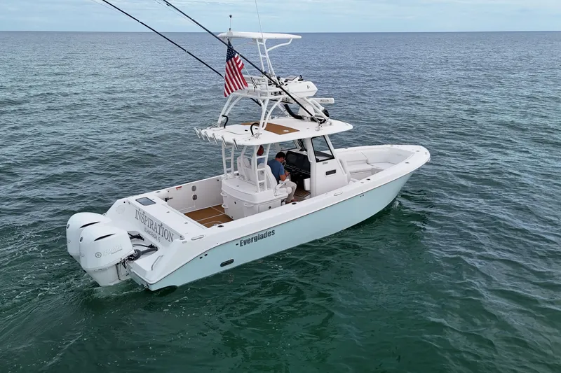 Slide: The Image of 2018 Everglades 335 Center Console boat on open water, featuring dual engines and American flag. - 3