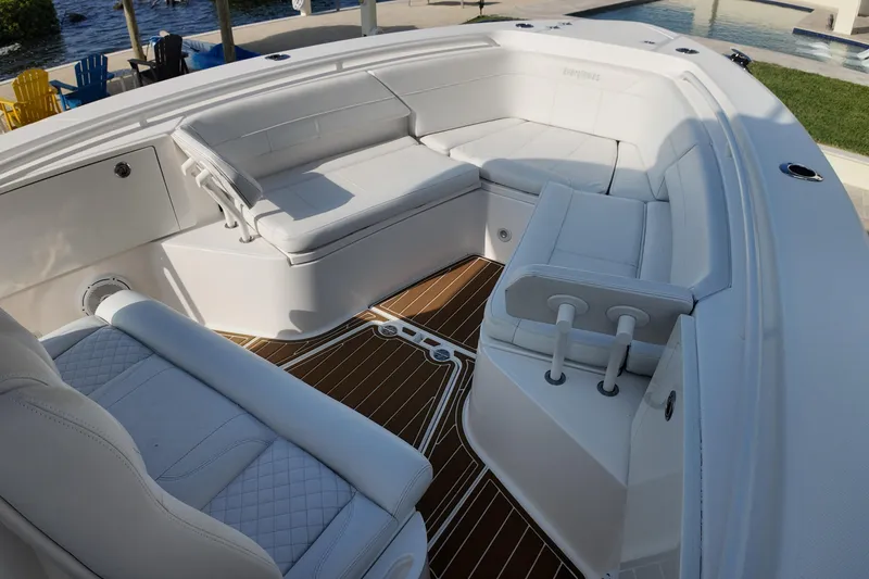 Slide: The Image of 2018 Everglades 335 Center Console boat with luxurious white seating and teak flooring. - 31