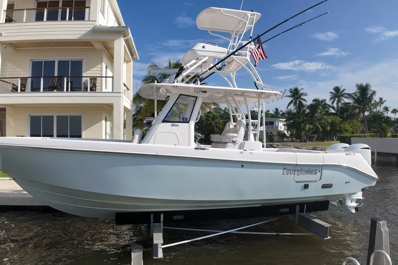 Slide: The Image of 2018 Everglades 335 Center Console boat docked near waterfront home. - 35