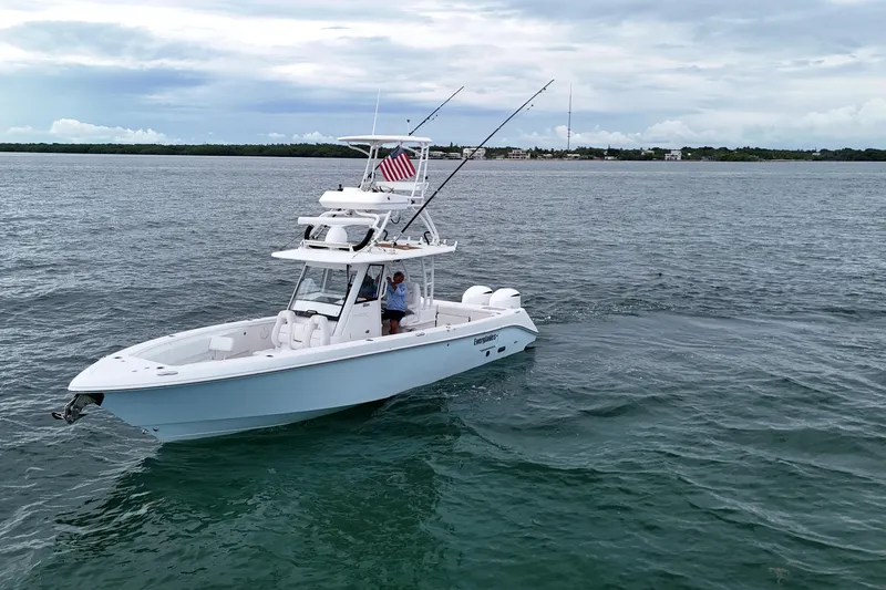 Slide: The Image of 2018 Everglades 335 Center Console boat on open water with fishing rods and American flag. - 8