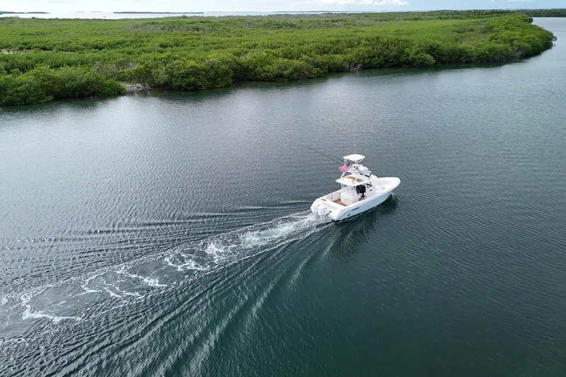 Slide: The Image of 2018 Everglades 335 Center Console boat cruising in scenic waterway. - 9