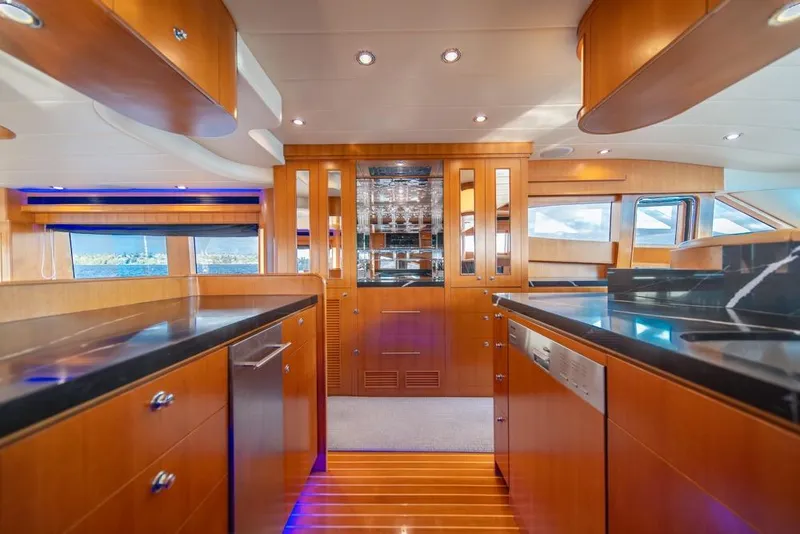 Slide: The Image of Luxurious interior of 2009 Horizon 73 yacht with modern kitchen and wooden cabinetry. - 16