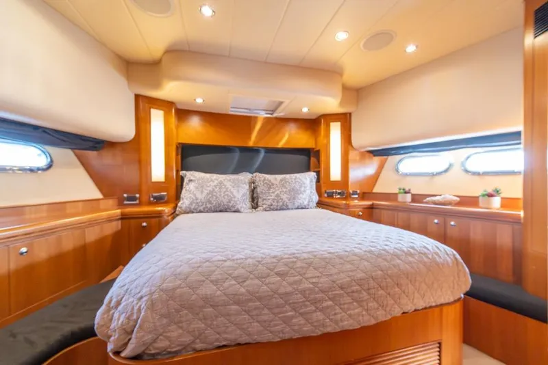 Slide: The Image of Luxurious bedroom interior of 2009 Horizon 73 yacht with elegant wood paneling and cozy bedding. - 29