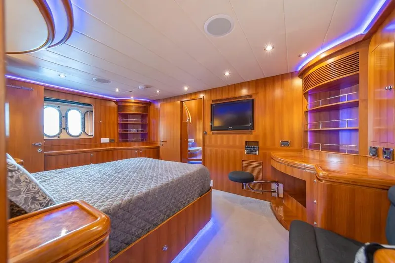 Slide: The Image of Luxurious 2009 Horizon 73 yacht bedroom with elegant wood paneling and ambient lighting. - 30