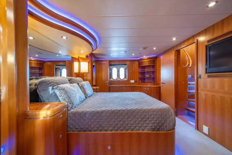 Slide: The Image of Luxurious 2009 Horizon 73 yacht bedroom with elegant wood finish and ambient lighting. - 35