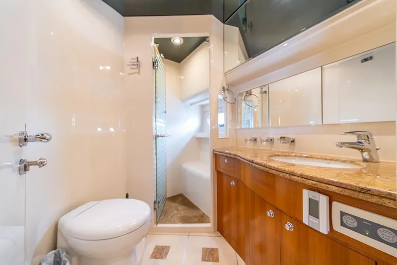 Slide: The Image of Luxurious bathroom in 2009 Horizon 73 yacht with modern fixtures and elegant wood cabinetry. - 42
