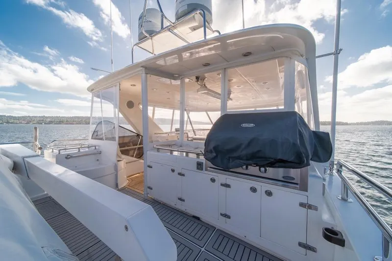 Slide: The Image of Luxurious 2009 Horizon 73 yacht deck with covered grill and ocean view. - 45