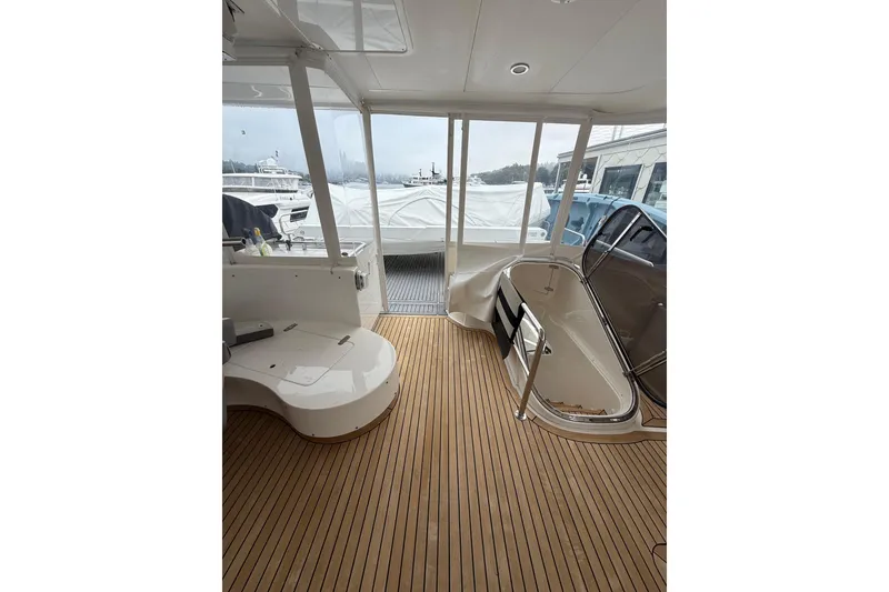 Slide: The Image of Interior view of a 2009 Horizon 73 yacht with wooden flooring and seating area. - 47