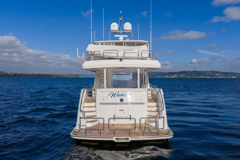 Slide: The Image of Luxury Horizon 73 yacht from 2009 on open water, clear sky background. - 5