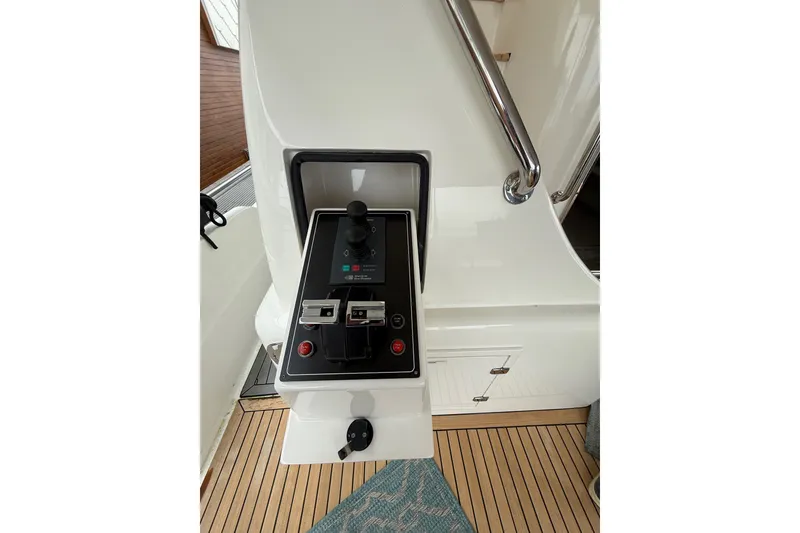 Slide: The Image of Control panel on a 2009 Horizon 73 yacht, featuring joystick and switches. - 51