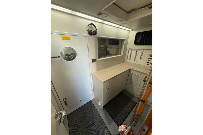 Slide: The Image of Interior of 2009 Horizon 73 yacht with control panel and storage cabinets. - 52