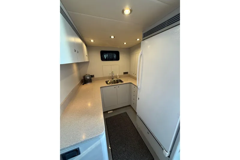 Slide: The Image of Compact kitchen interior of 2009 Horizon 73 yacht with modern appliances and sleek design. - 53