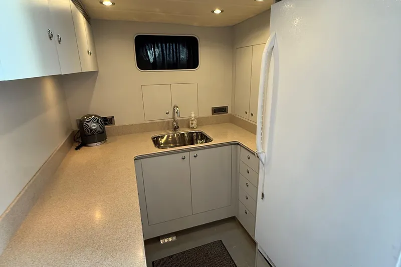 Slide: The Image of Compact kitchen in a 2009 Horizon 73 yacht with modern appliances and sleek cabinetry. - 54