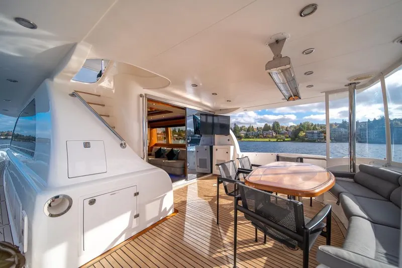 Slide: The Image of Luxurious 2009 Horizon 73 yacht deck with seating, dining area, and scenic water view. - 59