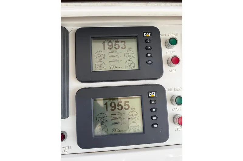 Slide: The Image of Control panel of a 2009 Horizon 73 yacht with engine displays and start/stop buttons. - 64
