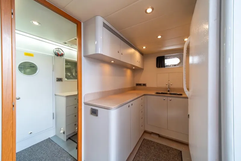 Slide: The Image of Modern kitchen interior on 2009 Horizon 73 yacht, featuring sleek cabinetry and compact design. - 69