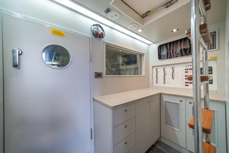 Slide: The Image of Modern yacht interior with control panels, storage cabinets, and ladder, Horizon 73, 2009 model. - 70