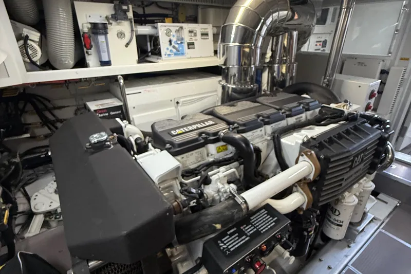 Slide: The Image of Engine room of a 2009 Horizon 73 yacht featuring a Caterpillar engine. - 73