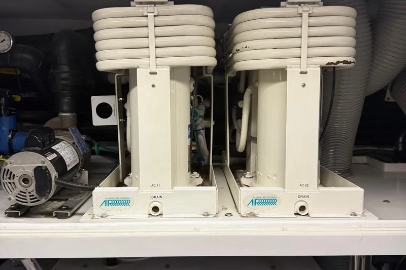 Slide: The Image of Dual marine air conditioning units in a Horizon 73, 2009 model, with visible coils and pump. - 74
