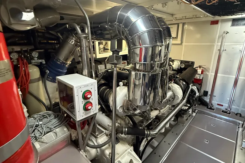 Slide: The Image of Engine room of a 2009 Horizon 73 yacht with polished metal components. - 77