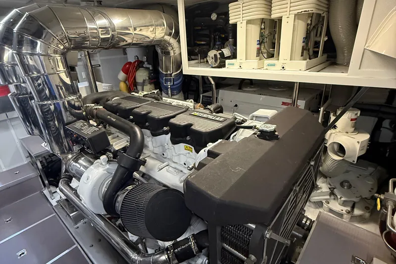 Slide: The Image of Engine room of a 2009 Horizon 73 yacht, featuring a Caterpillar engine. - 78