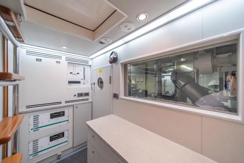 Slide: The Image of Engine room of 2009 Horizon 73 yacht with control panels and machinery. - 79