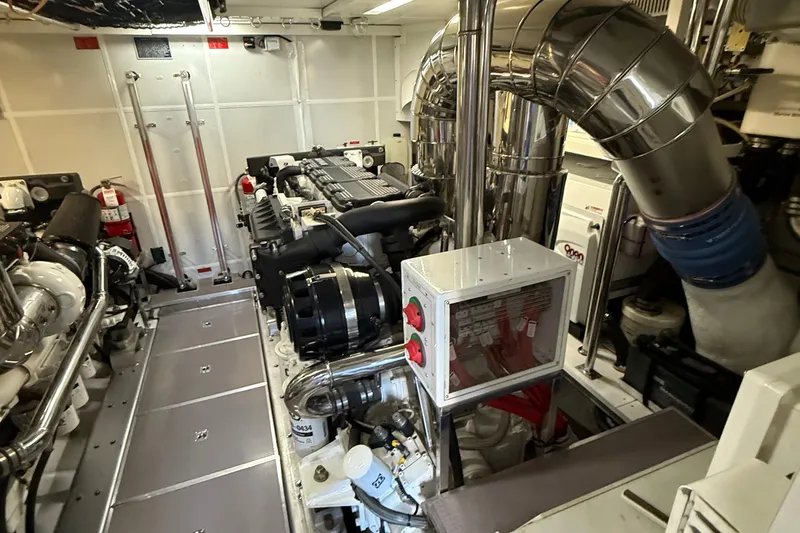 Slide: The Image of Engine room of a 2009 Horizon 73 yacht, featuring complex machinery and piping. - 80