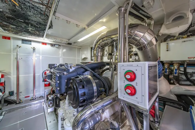 Slide: The Image of Engine room of a 2009 Horizon 73 yacht, featuring complex machinery and control systems. - 84