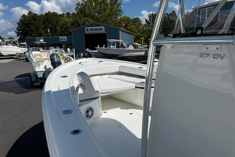 Slide: The Image of 2026 Pair Customs 27 Center Console boat at a Suzuki dealership, showcasing sleek design. - 10