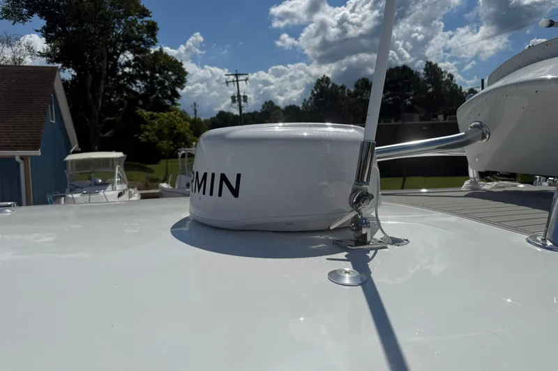 Slide: The Image of 2026 Pair Customs 27 Center Console boat with Garmin equipment under a sunny sky. - 4