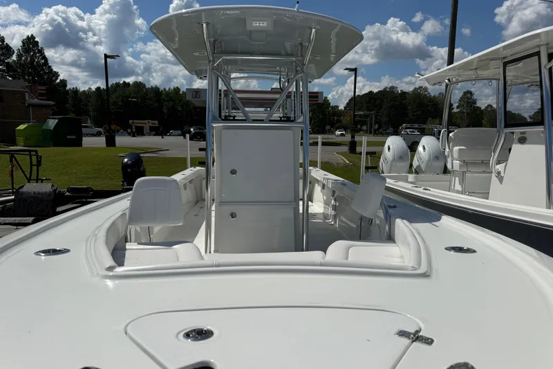 Slide: The Image of 2026 Pair Customs 27 Center Console boat with sleek design, parked outdoors under a cloudy sky. - 6