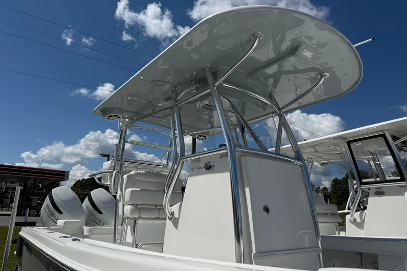 Slide: The Image of 2026 Pair Customs 27 Center Console boat with sleek design and dual engines under a blue sky. - 7