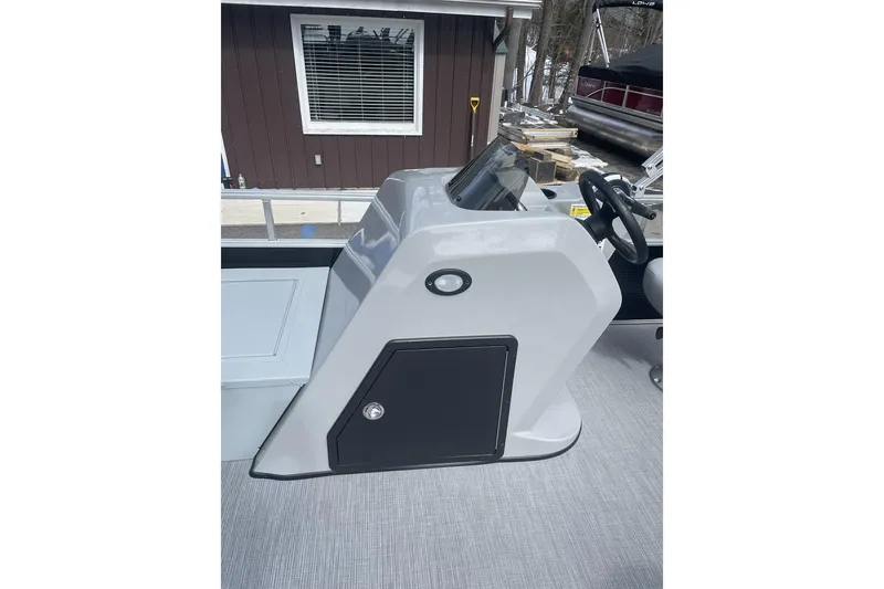 Slide: The Image of 2024 Lowe Ultra 162 Fish & Cruise boat console with steering wheel and storage compartment. - 11