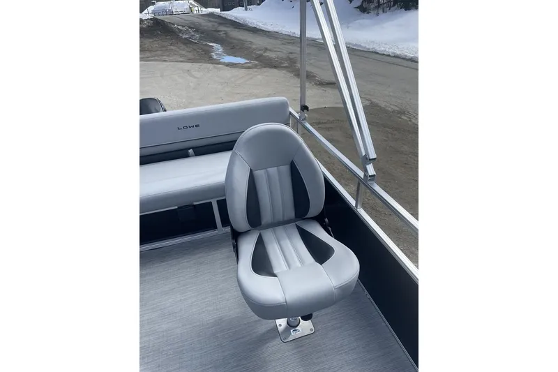 Slide: The Image of 2024 Lowe Ultra 162 Fish & Cruise boat seat, gray upholstery, outdoor setting. - 12