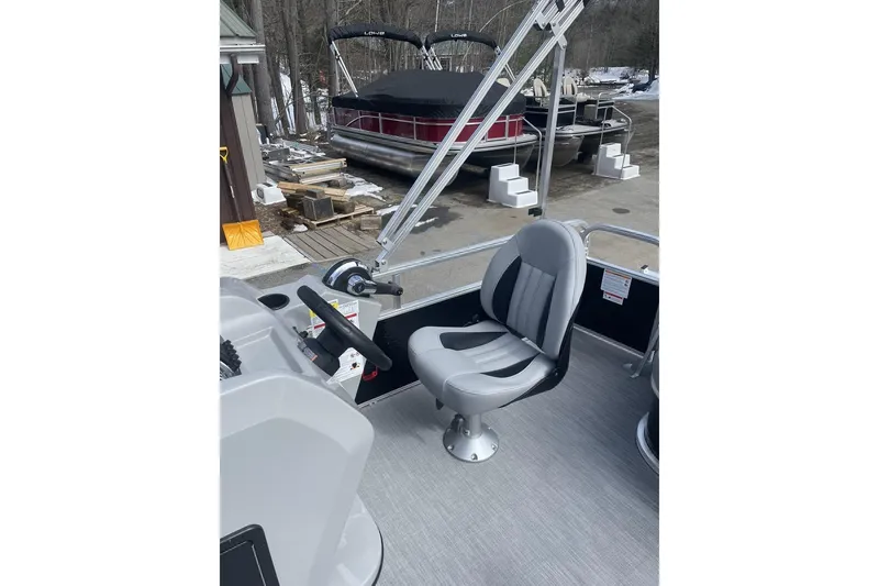 Slide: The Image of 2024 Lowe Ultra 162 Fish & Cruise boat interior with steering wheel and seat. - 13