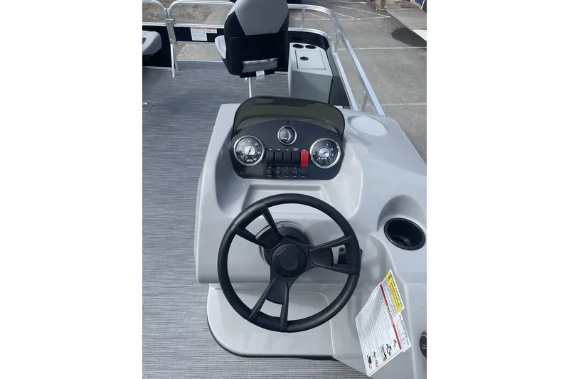 Slide: The Image of 2024 Lowe Ultra 162 Fish & Cruise boat dashboard with steering wheel and controls. - 15