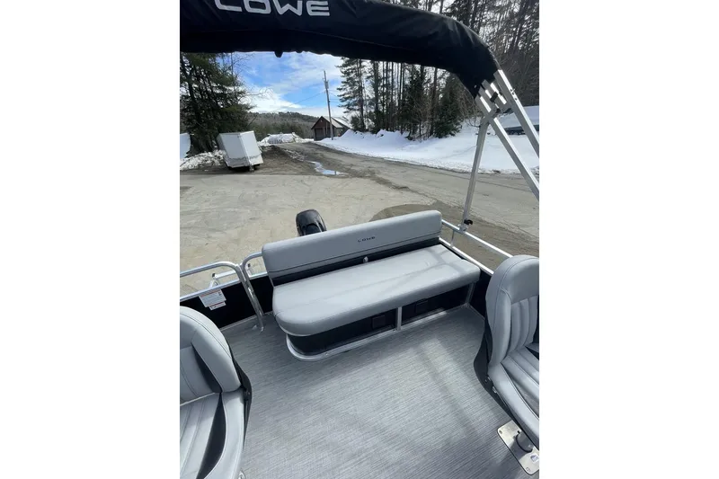 Slide: The Image of 2024 Lowe Ultra 162 Fish & Cruise boat interior with seating, parked on snowy ground. - 16