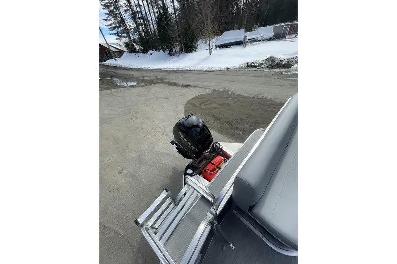 Slide: The Image of 2024 Lowe Ultra 162 Fish & Cruise boat with outboard motor in snowy setting. - 17