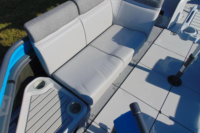Slide: The Image of 2023 Sea-Doo Switch Cruise 21 interior seating with cup holders and modern design. - 10