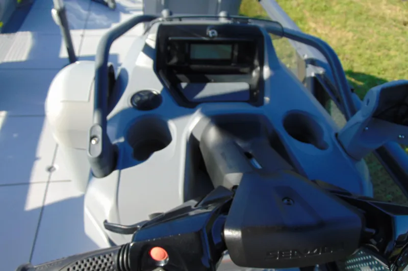 Slide: The Image of 2023 Sea-Doo Switch Cruise 21 dashboard with steering controls and cup holders. - 15