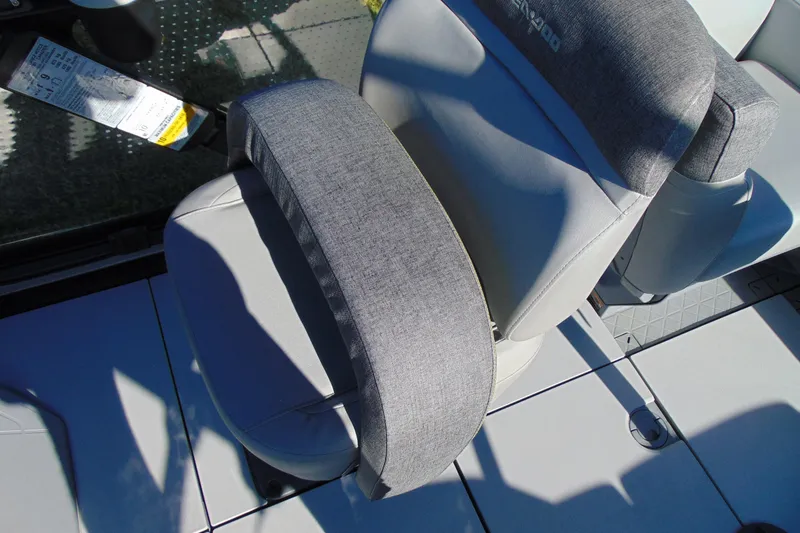 Slide: The Image of 2023 Sea-Doo Switch Cruise 21 boat seat with gray upholstery and armrest. - 17