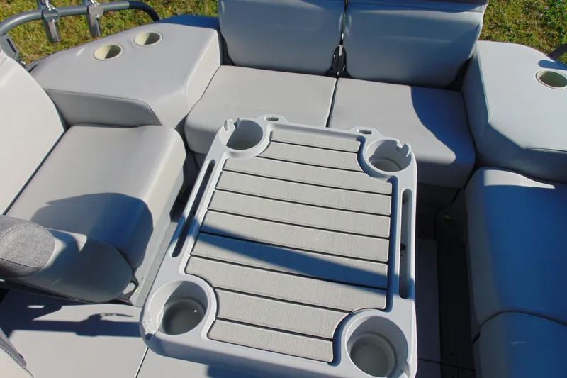 Slide: The Image of 2023 Sea-Doo Switch Cruise 21 interior with seating and table, featuring cup holders. - 18