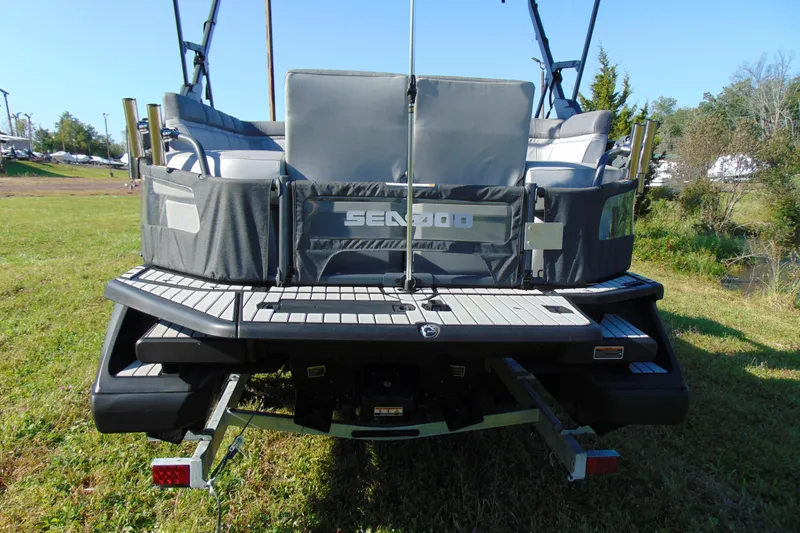 Slide: The Image of 2023 Sea-Doo Switch Cruise 21 rear view on grassy terrain. - 4